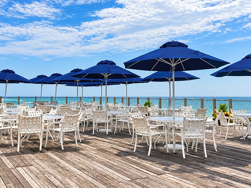 Cafe patio with movable tables and folding commercial fabric umbrellas